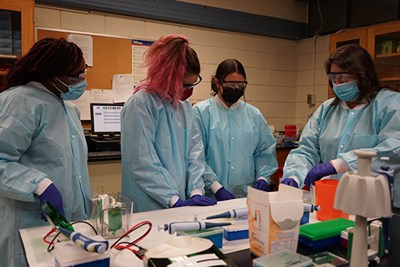 UML pharmaceutical sciences majors Khadija Sinkinah (left) and Christina Ciaramitaro (second from right) with nutritional sciences student Sadie Reppucci (second from left) and biomedical lab sciences specialist Kellee Cardaleen