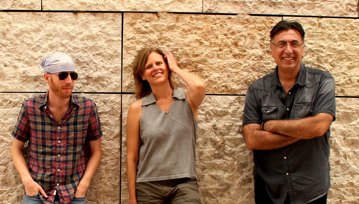 Group photo of musical group Blue Thread:  Yaniv Yacoby, strings Cristi Catt, soprano Nikola Radan, flutes standing side by side against a wall.