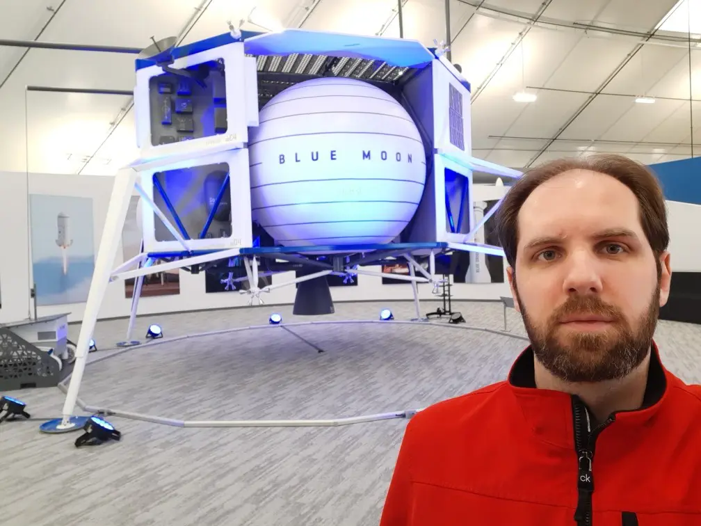 UML Alumni Platen Atanosov stands in front of "Blue Moon," a lunar lander at Blue Origin.