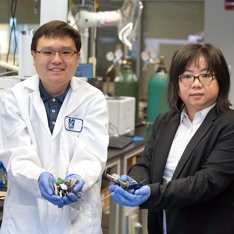 Evan Yu and Asst. Prof. Wan-Ting (Grace) Chen hold crushed pieces of waste from electronics