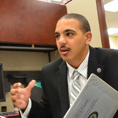 Student in the UMass Lowell political science program holds a binder