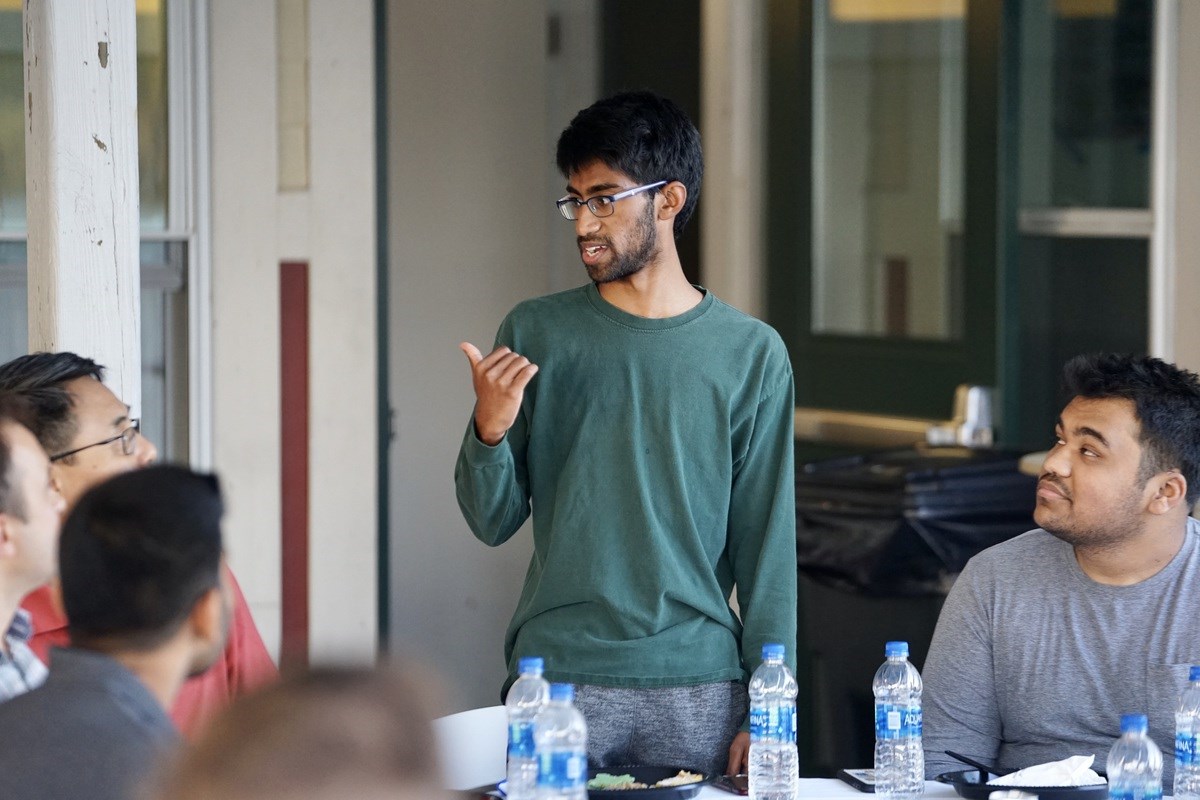 UMass Lowell student Prabakar Adithya speaks with a group of students