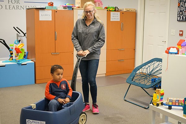 Alexis Kitsakos '15 gives a child a break from learning tasks.