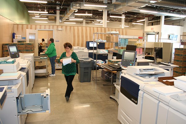 Print center staff members work in new facility