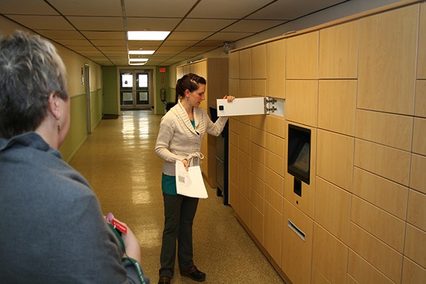 A faculty member is shown the new locker system at Cumnock