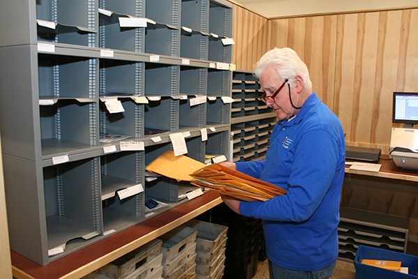 John Eaton sorts mail in the new mailroom