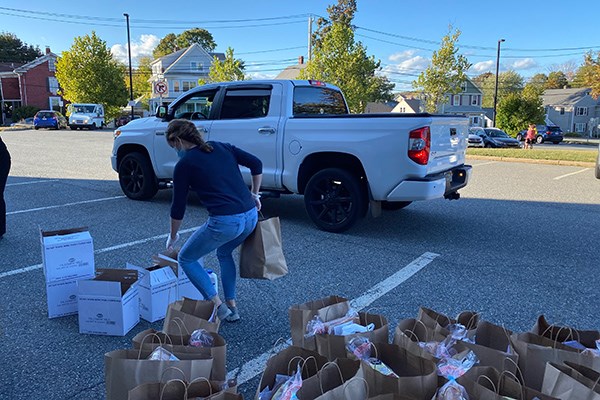 MPH dietetics student Kate Killion loads up free breakfast and lunches for schoolchildren in Waltham, Mass., during the COVID-19 pandemic