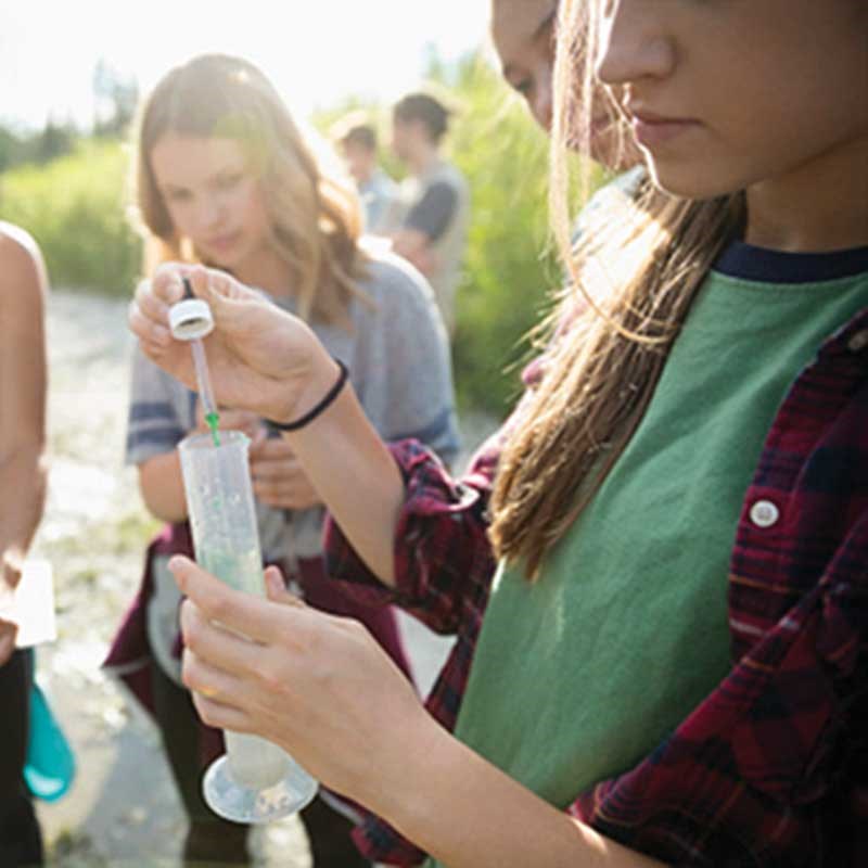 Public Health students at UMass Lowell collect water samples outdoors