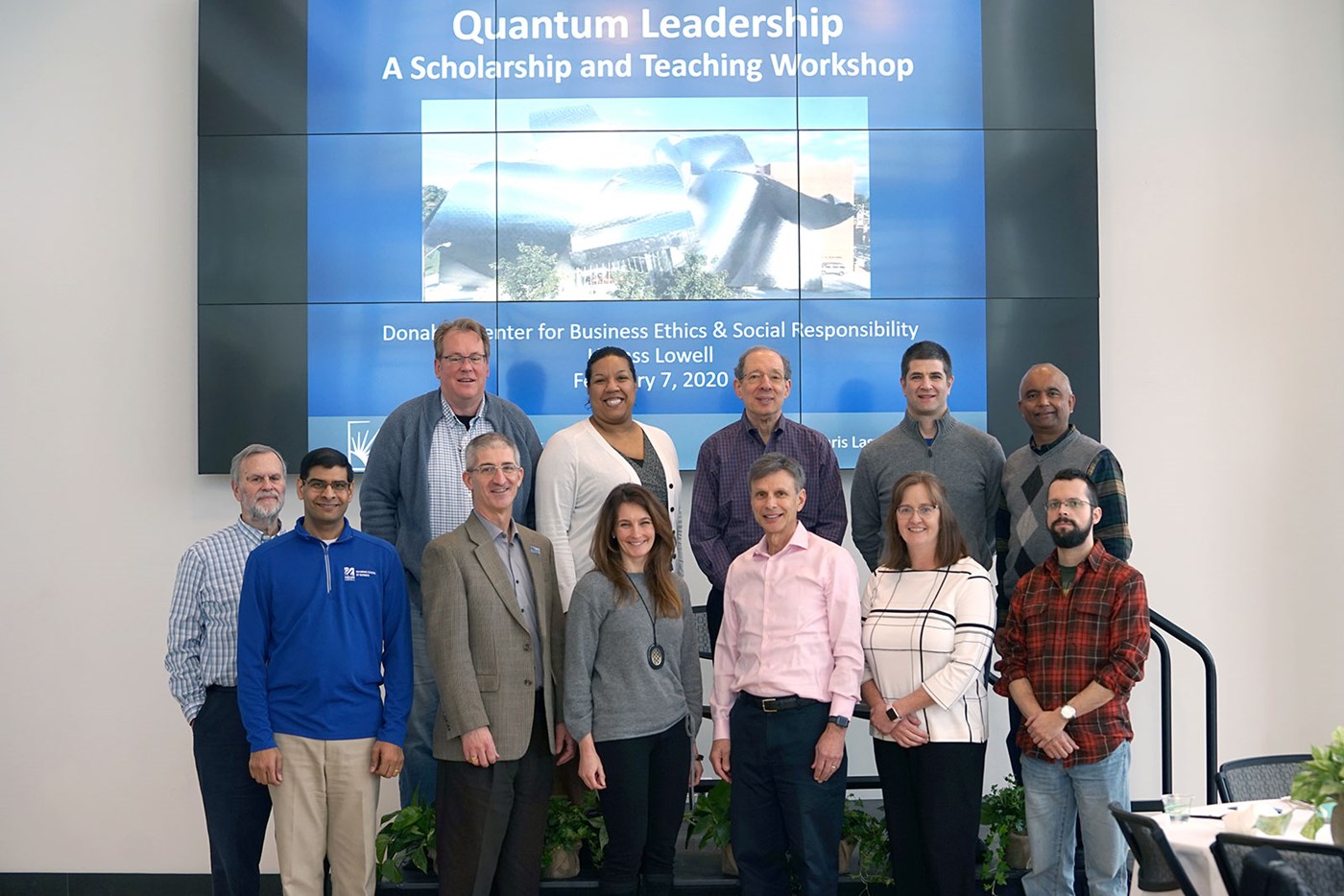 Group standing in front of slide for Quantum Leadership Workshop