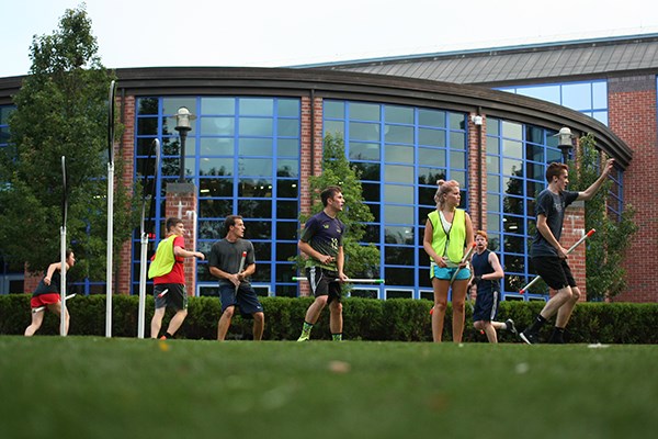 Club quidditch team players practice outside the Rec Center