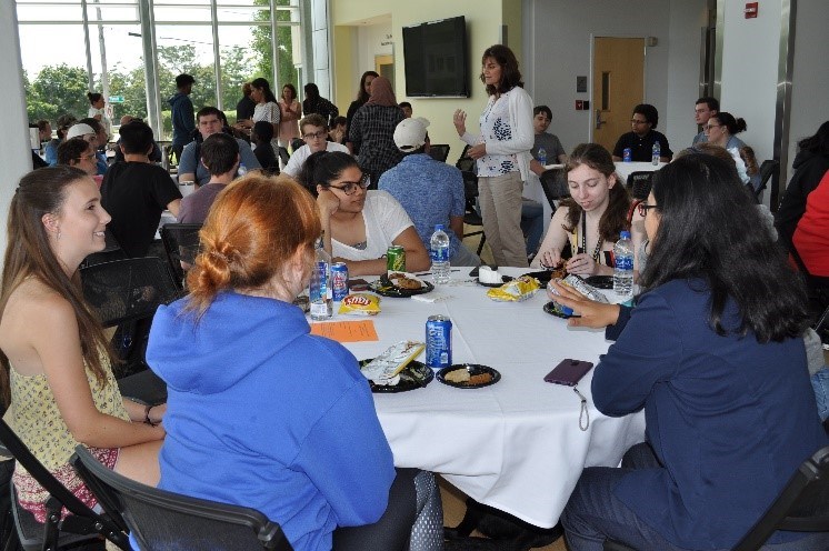 Students at round tables in conference setup