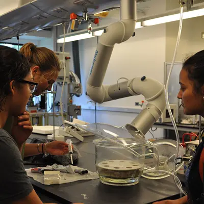 Three students work on project in lab.