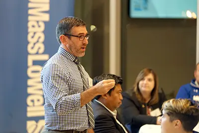 Matthew Hurwitz talks to participants at the kickoff dinner