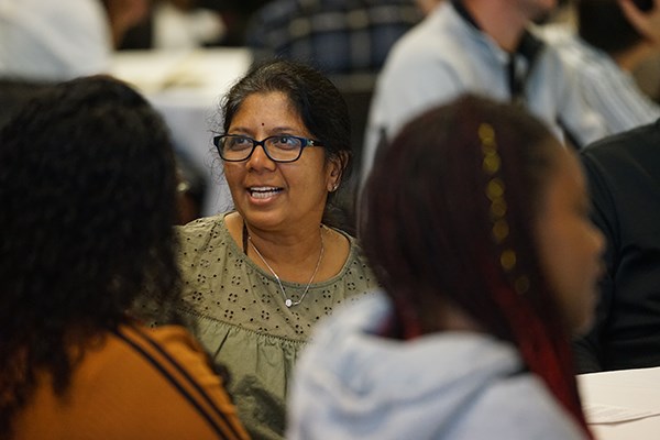 Purvi Patel speaks with people at the dinner