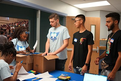 Sophomore Marie Bernier checks in new members of the River Hawk Scholars Academy at UMass Lowell.