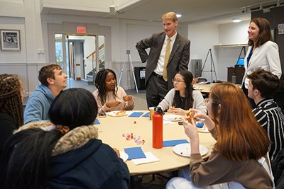 UMass Lowell Provost Joe Hartman and Jennifer Percival, associate dean of the Manning School of Business, chat with River Hawk Scholars who got scholarships from the Independent University Alumni Association at Lowell