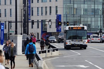 A Lowell city bus crossing the Howe Bridge on campus