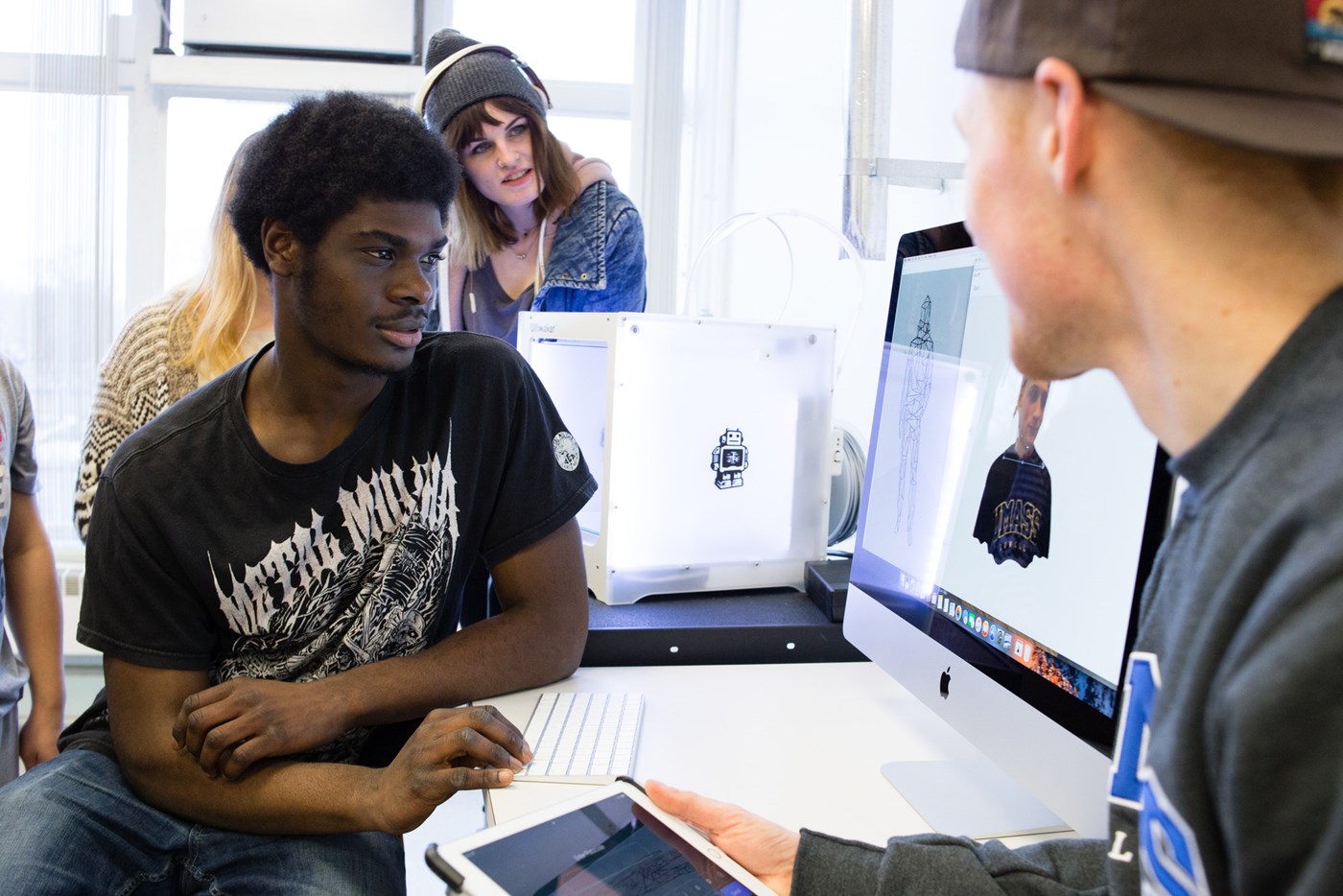 Students use a 3D printer in Art & Design Department FabLab in Dugan Hall