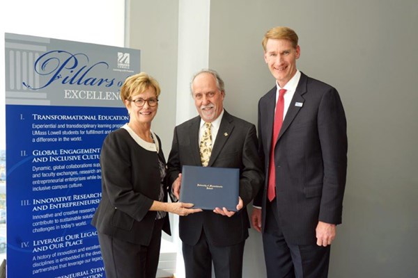 Chancellor Jacquie Moloney and Provost Joseph Hartman congratulate William Moylan, center, on becoming the university's 12th University Professor