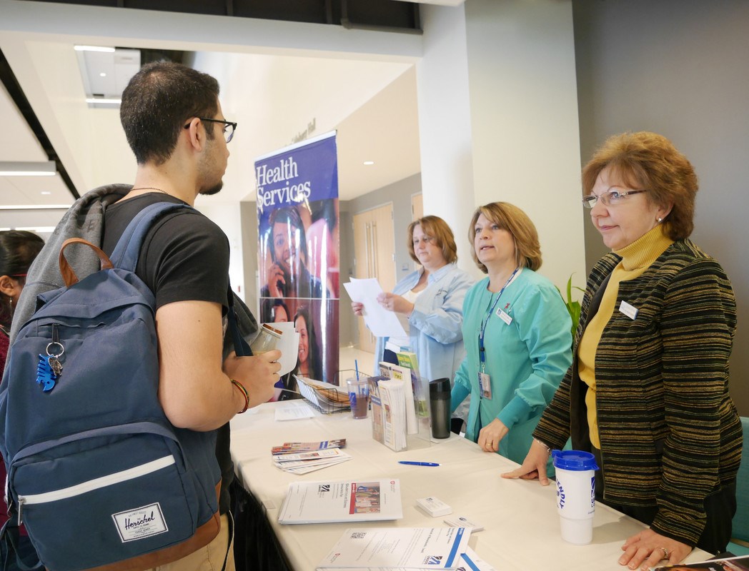 Students talk to representatives from Health Services at the International Student Resource Fair