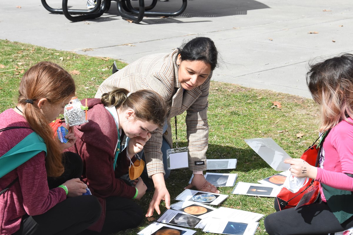 Prof. Ramanpreet Kaur showing space related activity cards to girl scout visitors