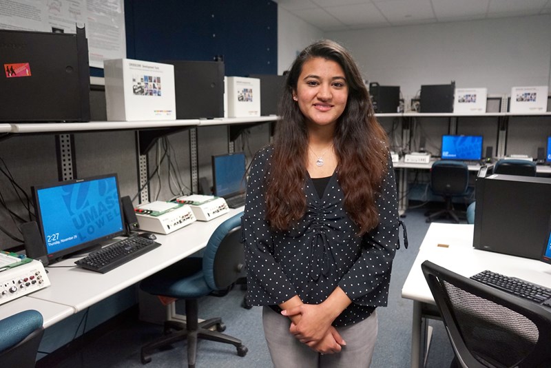 Ramsha Farooq stands in an engineering computer lab at UMass Lowell