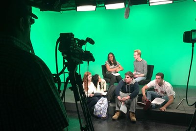   “Members of the Chelmsford High School drama club take a break during filming of a video about first-year students’ transition to college.”