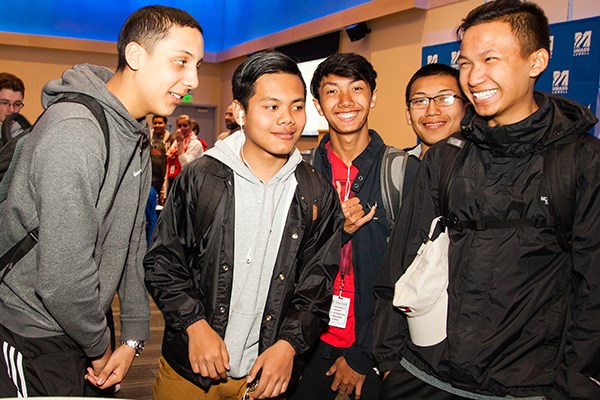 Rifat Islam (left) jokes with his friends at the final service learning celebration.