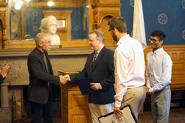John Palma shakes hands with Jay Mason at City Hall