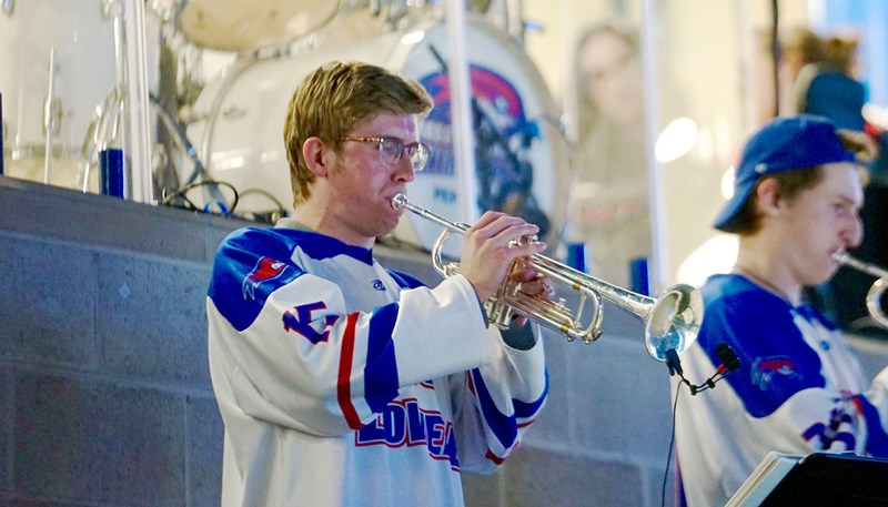 ryan playing an instrument at a hockey game 