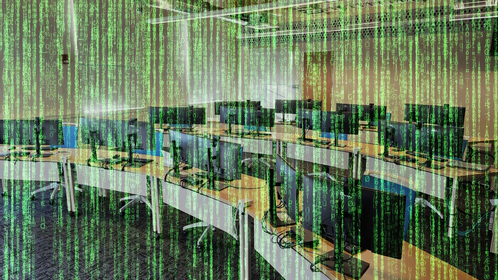 A bunch of desks with computer equipment on them with a layer of Matrix like green code over it.