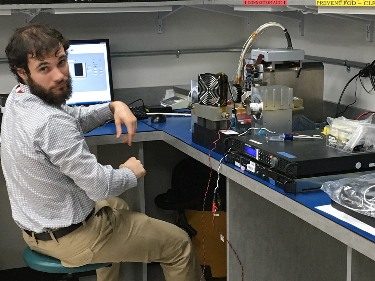 Sam Fingerman, LoCSST staff member, is shown here at BAE Systems testing the control software for the instrument for the MISTIC WINDS project.