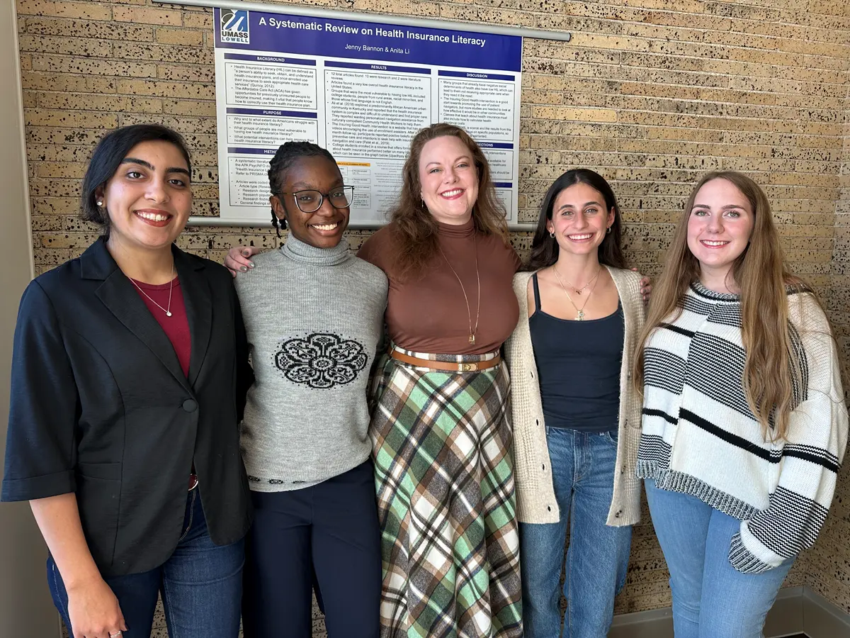 Psychology Assistant Professor Sarah Merrill stands in a line with four students