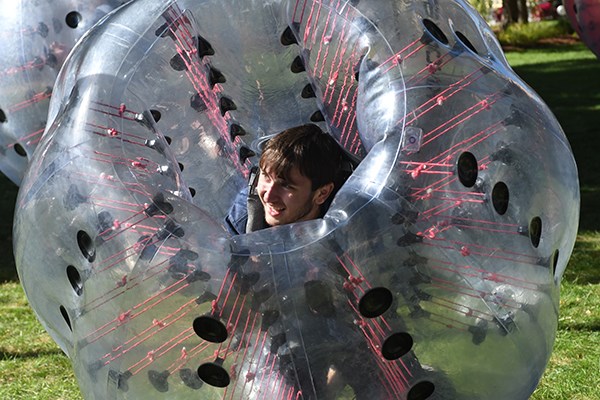 A student in an inflatable bumper ball