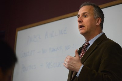 UMass Lowell Prof. Scott Latham in front of white board