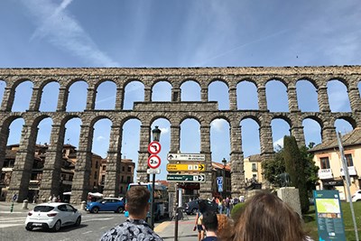 UML Honors study abroad students visit the Roman aqueduct in Segovia, Spain, as part of their Madrid trip