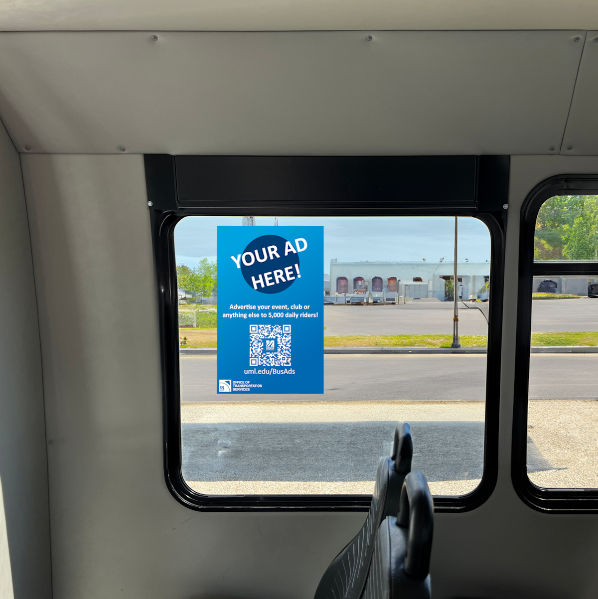 A blue example advertisement is displayed on the inside window of a shuttle.