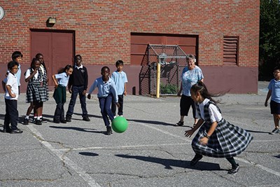 Sister Joanne Sullivan on the playground with fourth-graders at recess.