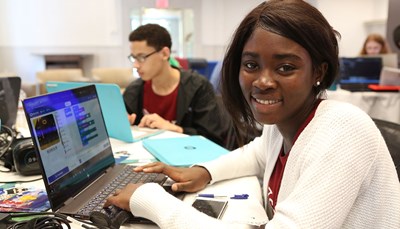Young woman works on laptop