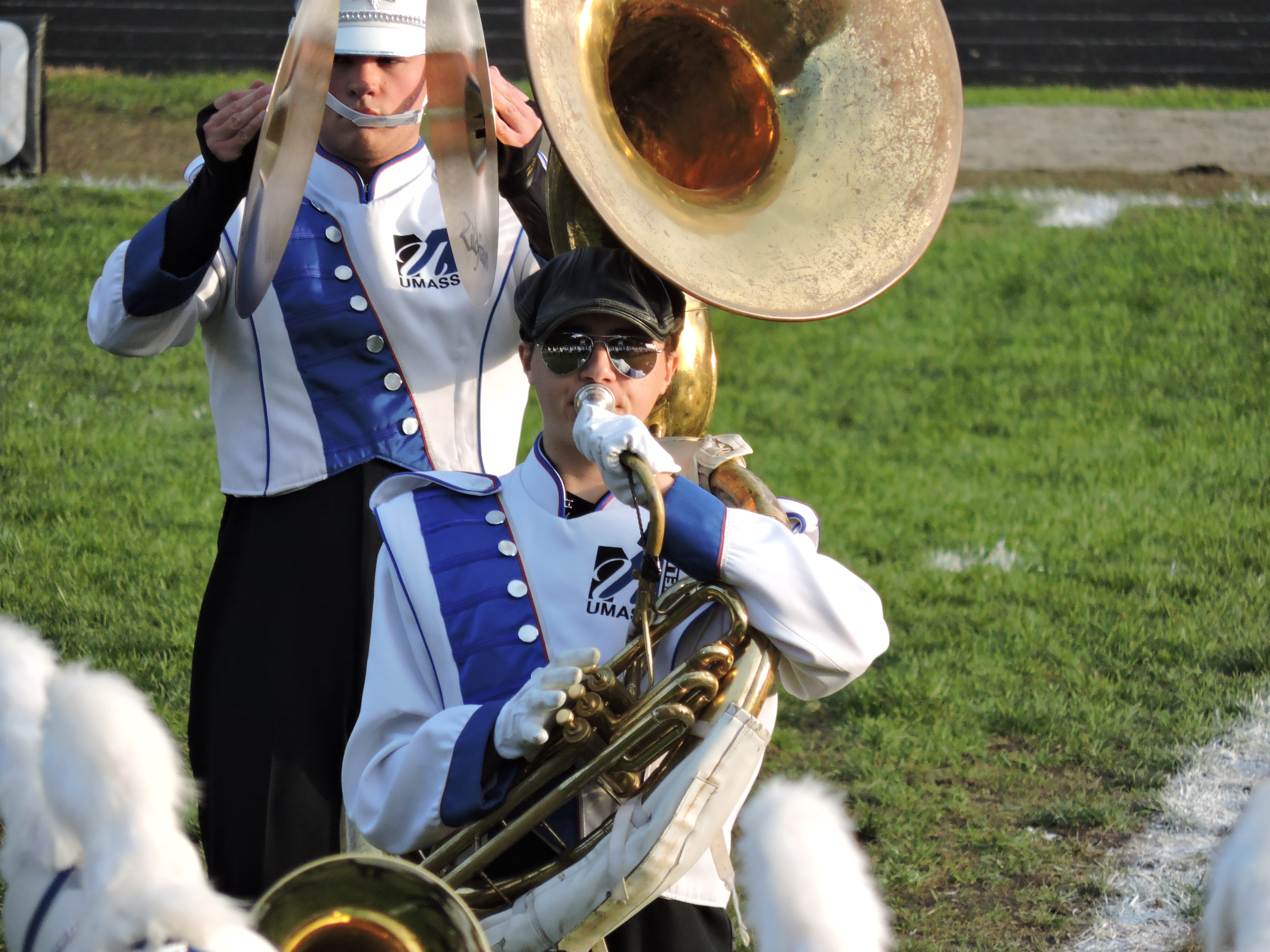 shows two musicians, a Sousaphone & Cymbal player