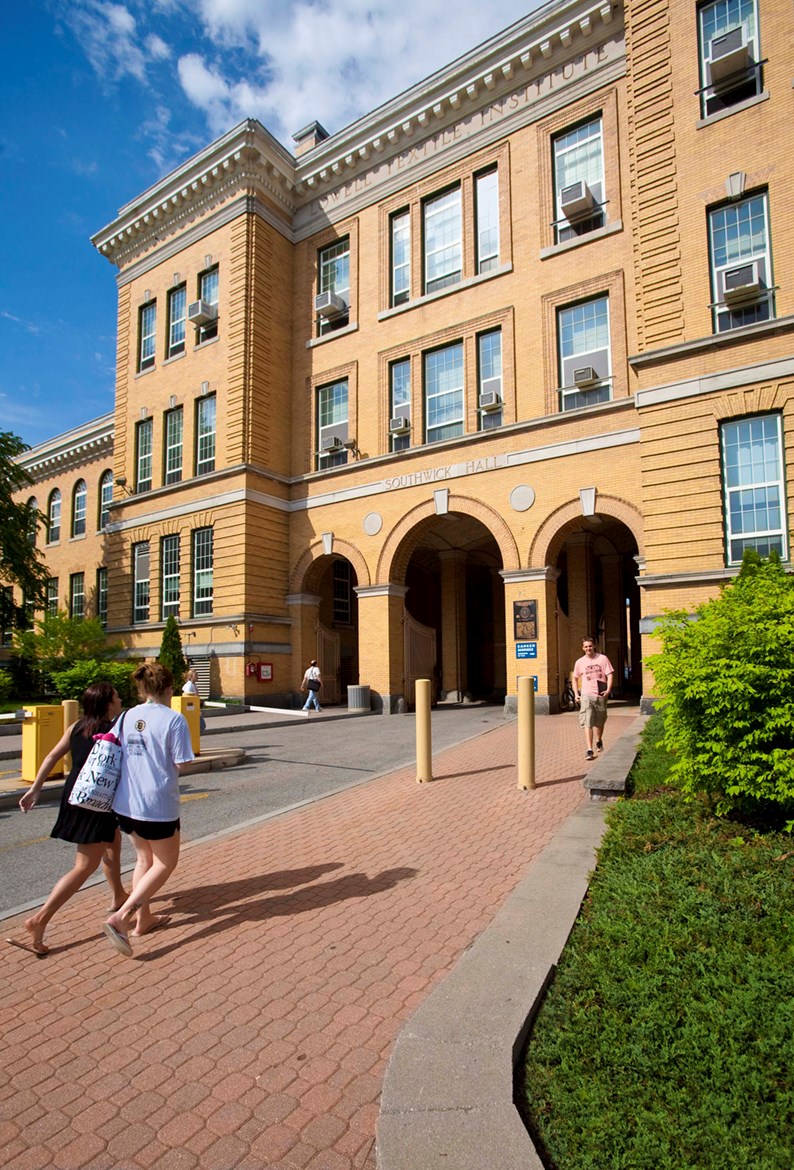 Students walking outside of Southwick Hall on North Campus on a sunny day