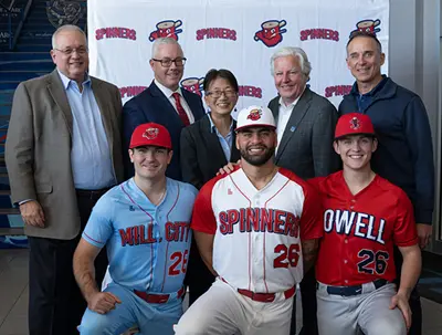 The community celebrated the return of the Lowell Spinners as the latest franchise of the Futures Collegiate Baseball League on Tuesday, Nov. 18, at a press conference held at the Tsongas Center at UMass Lowell. Wearing the team's new uniforms, front row, from left, franchise team leaders Matt Scibilio, Dawy LeBron and Ben Croteau. Back row, from left are, Lowell Spinners Chairman and CEO John Croteau, Lowell City Manager Tom Golden, UMass Lowell Chancellor Julie Chen, UMass President Marty Meehan and Spinners Principal Owner and Chief Baseball Officer Marc Deschenes. Photo: Bruce Preston for UMass Lowell.
