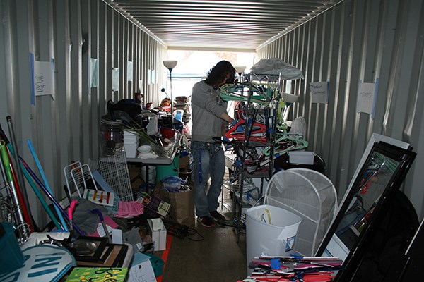 A student organizes donations in a shipping container