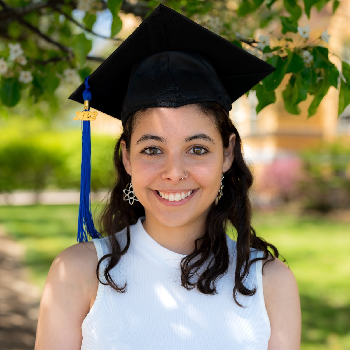 Cassia Fontes, Alumni of RadSci Program, headshot while wearing graduation cap