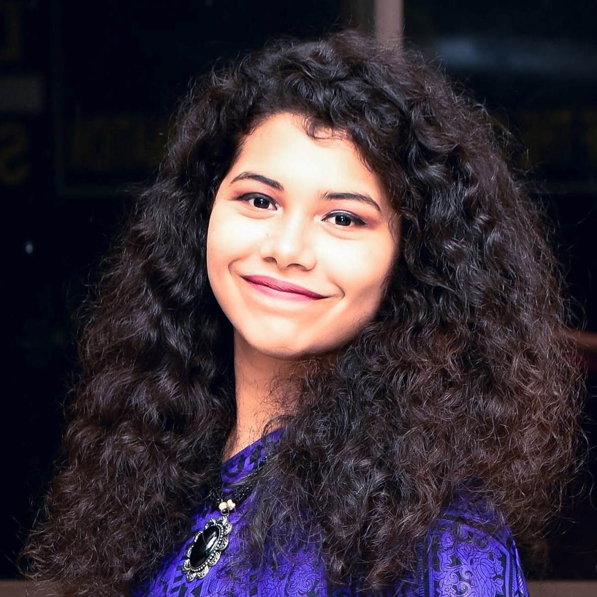 Ridhita, UML student, headshot picture in purple shirt