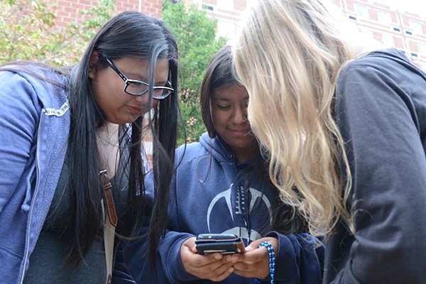Students check out an app on a mobile device