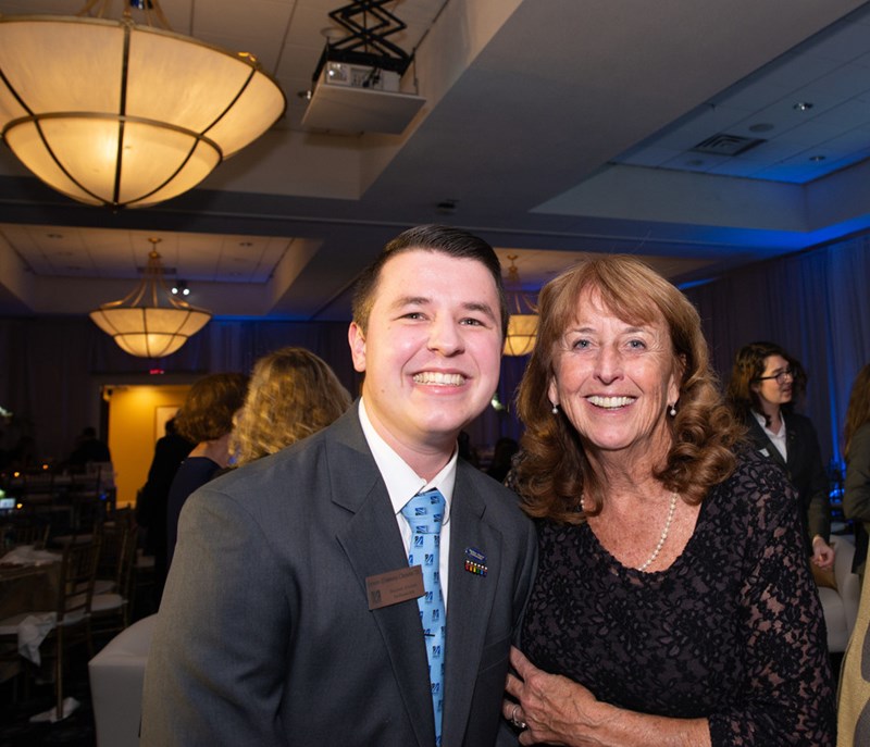 A Student Alumni Ambassador poses with an alum at the UMass Lowell 125th Anniversary Celebration gala