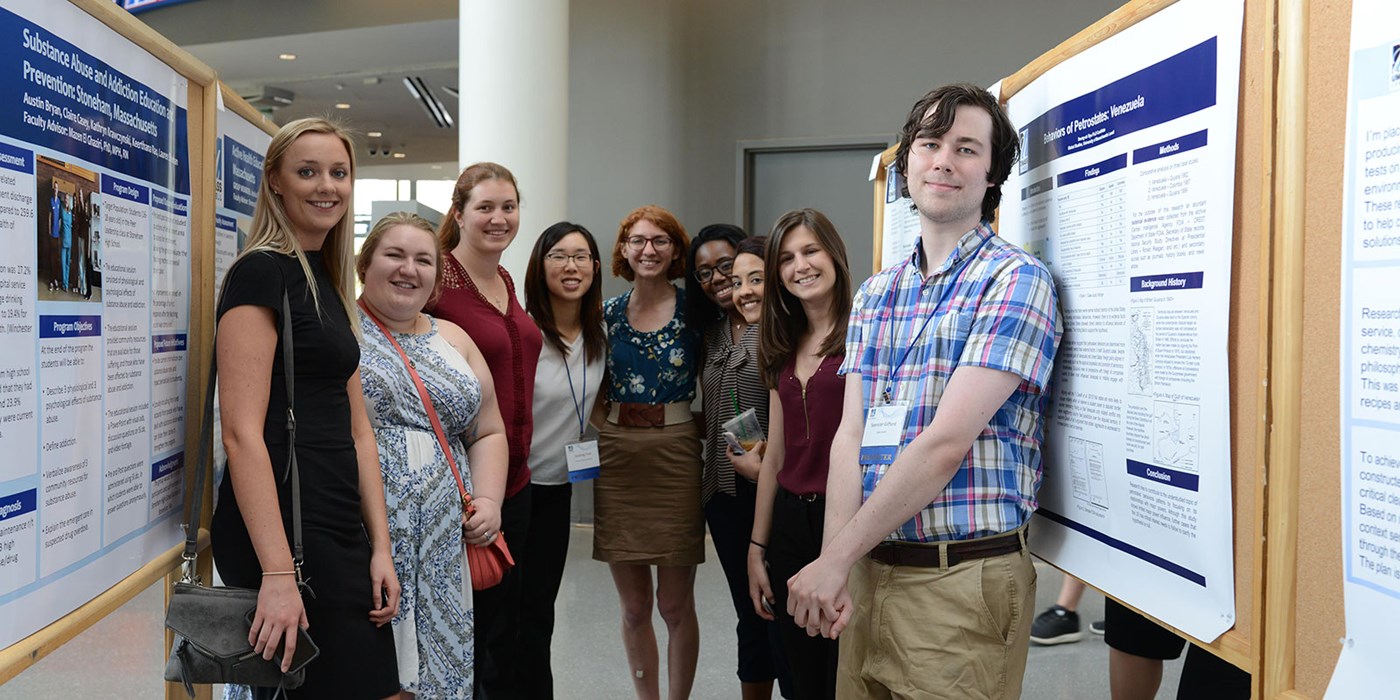 A group of students pose for a photo next to posters at the annual Student Research & Community Engagement Symposium. Open to all UMass Lowell undergraduate, graduate, and doctoral students, student research and community engagement projects are showcased as part of the judged poster presentation competition. Last year more than 200 posters representing nearly 30 departments were exhibited during the open poster session/reception.