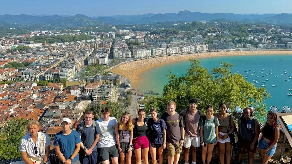 Group of students on hill overlooking bay
