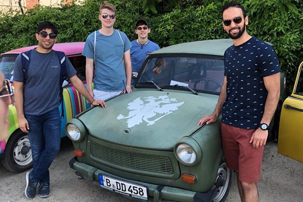 Students pose next to a Trabant car in Germany